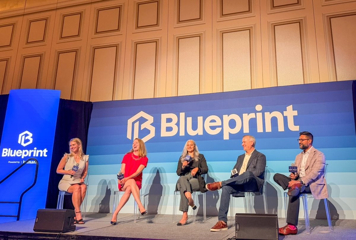 Dalia, seated center, speaking on a panel on the Blueprint conference stage