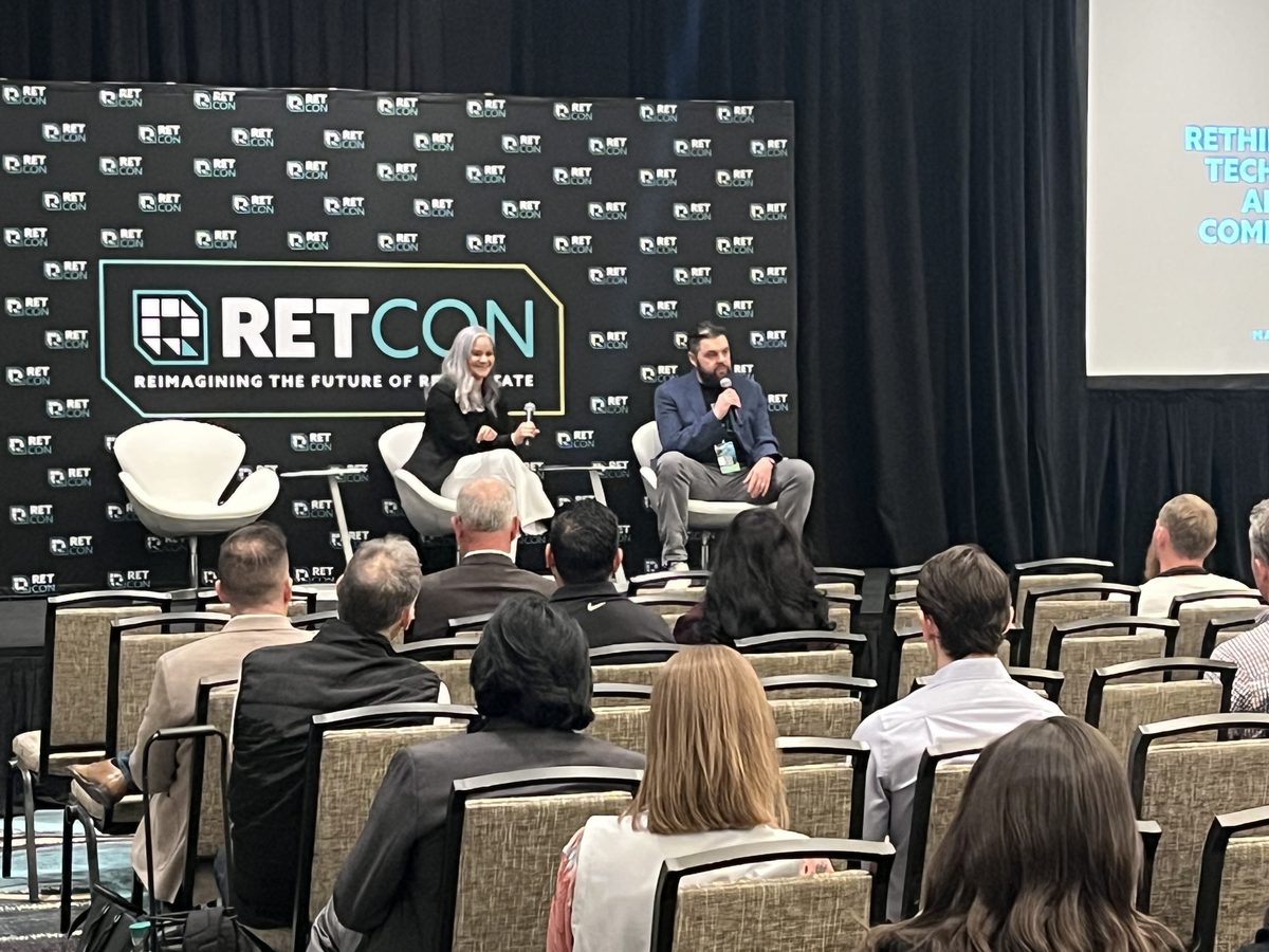 Dalia on stage at RETCON in conversation with a fellow speaker